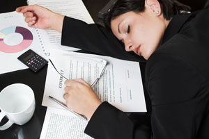 Chronic-Sleep-Deprivation-woman-sleep-on-desk.jpg